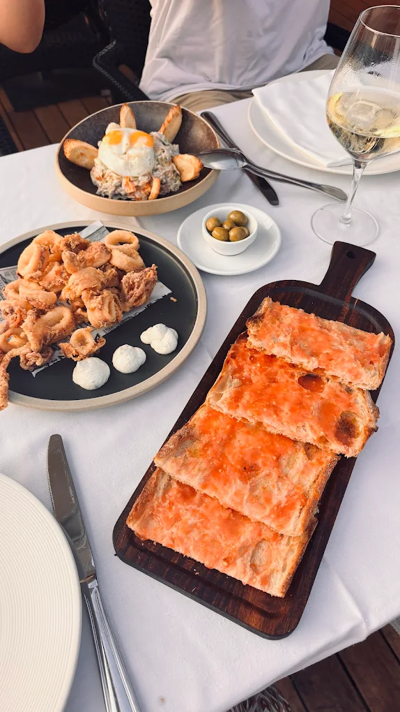 Spanish tapas — pan con tomate, calamares and white wine